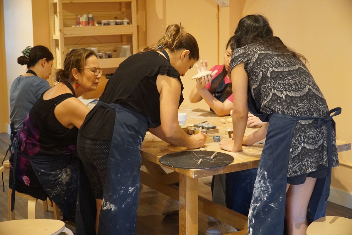 Diverse group enjoying a hand-building pottery session