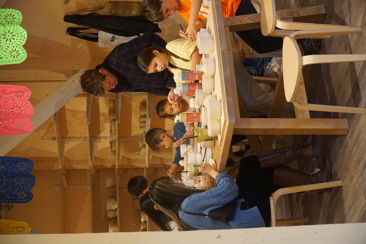 Kids working on pottery projects at a table at Olomana Studios