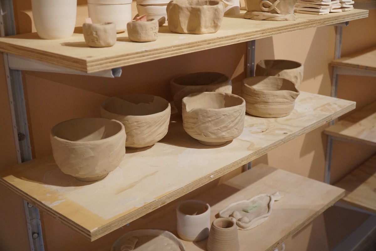 Matcha bowls drying on shelves at Olomana Studios